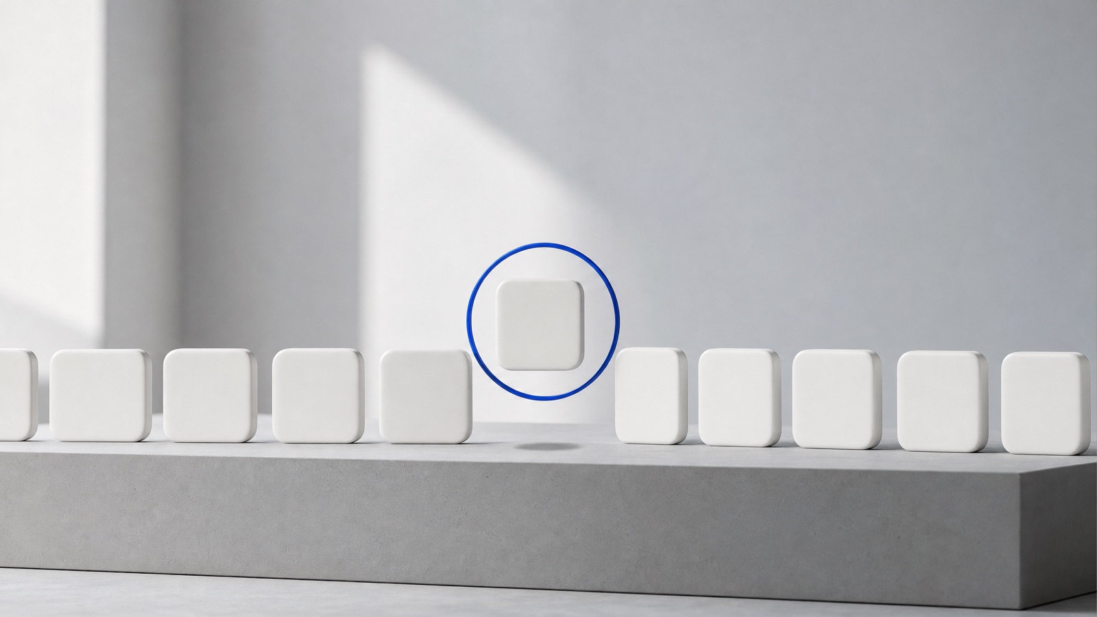 A row of white tiles on a grey plinth with one tile lifted out and held in a cobalt ring, a metaphor for an Instagram account suspended from the rest